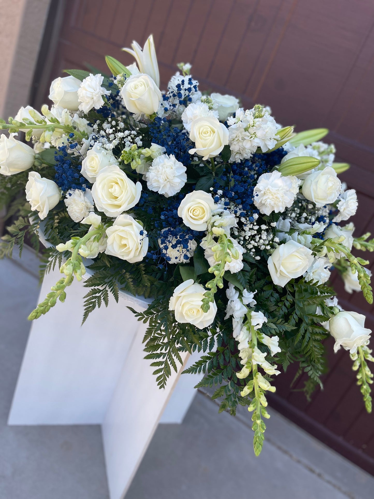 Blue and white casket spray